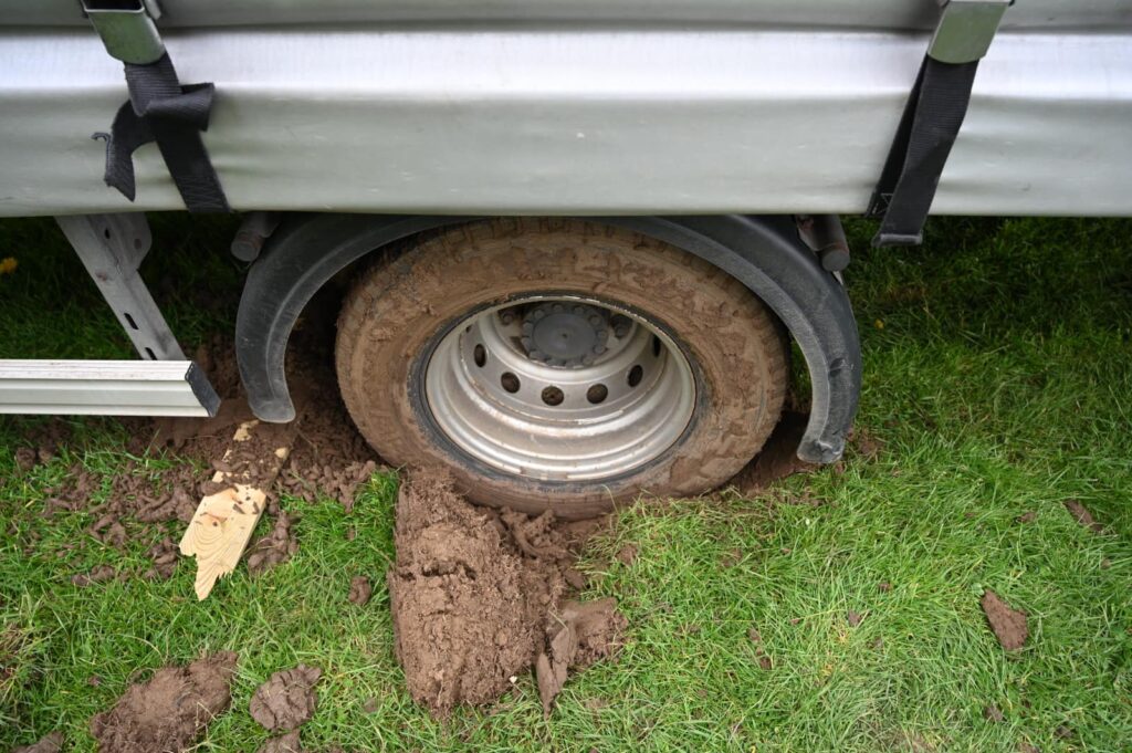 A van wheel stuck in mud